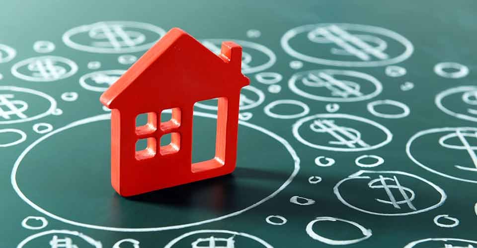 House model and painted dollar symbols on chalkboard