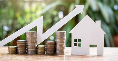 House model and stack coins for property investment mortgage