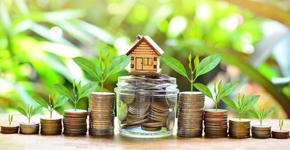 House model on coins for property investment
