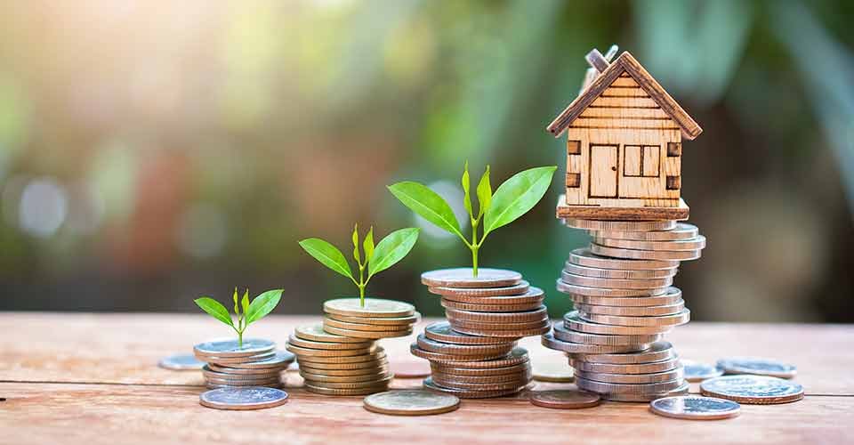 House model on money coins for downpayment