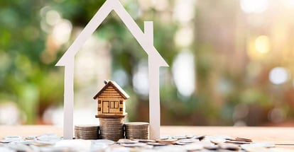House model on money coins for real estate investment