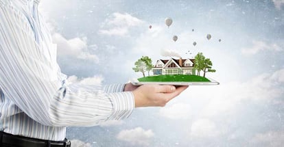 Human hands holding model of dream house