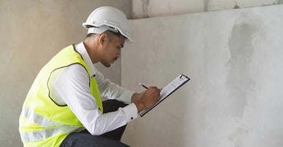 Inspector checking material and structure in construction