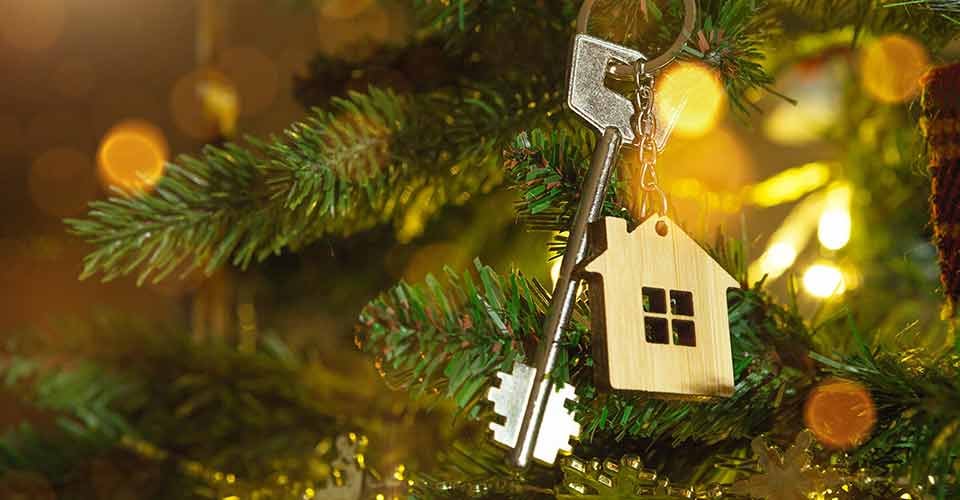 Key to the house with a keychain hanging on tree