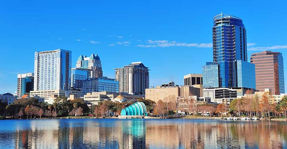 Lake Eola with urban skyscrapers and clear blue sky in Orlando Florida