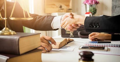 Lawyer shaking hand with buyer after counseling and giving advice