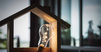 Light bulb inside wooden house