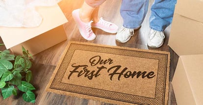 Man and Woman Unpacking Near Our First Home Welcome Mat