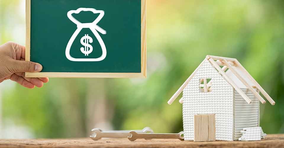 Man hand hold label board with money bag icon and loan to renovate home