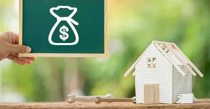 Man hand hold label board with money bag icon and loan to renovate home