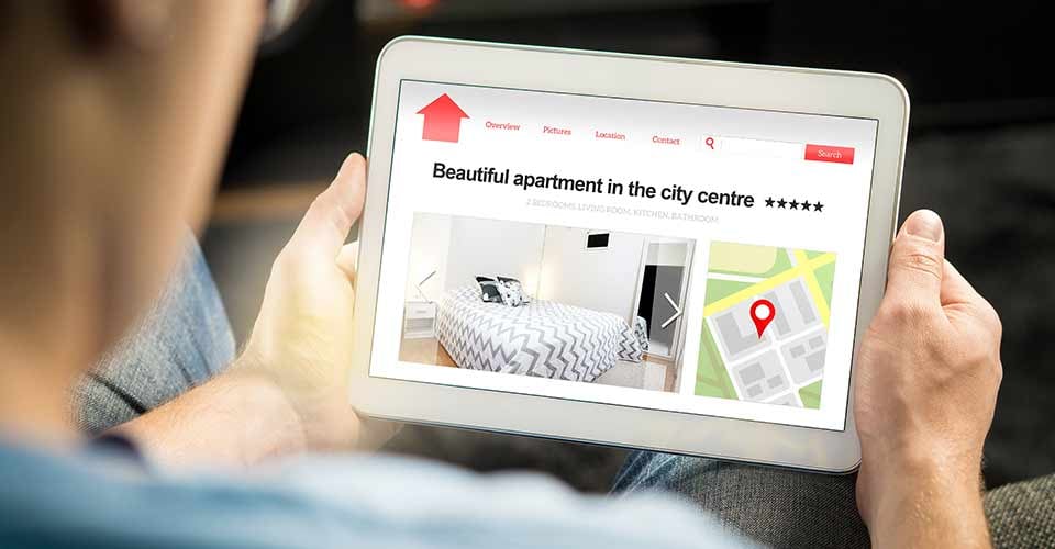 Man search apartments and houses online with mobile device