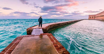 Man takes a morning walk on the moat around Port Jefferson at Dry Tortugas National Park