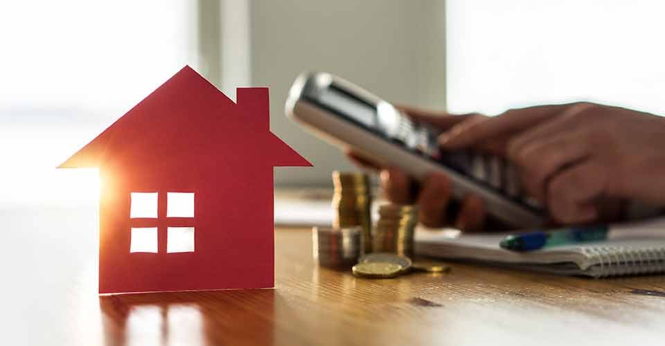 Man using calculator to count rental income from investment property