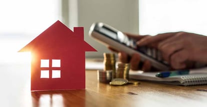 Man using calculator to count rental income from investment property