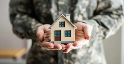 Military Army Man in Uniform Holding New House Modal