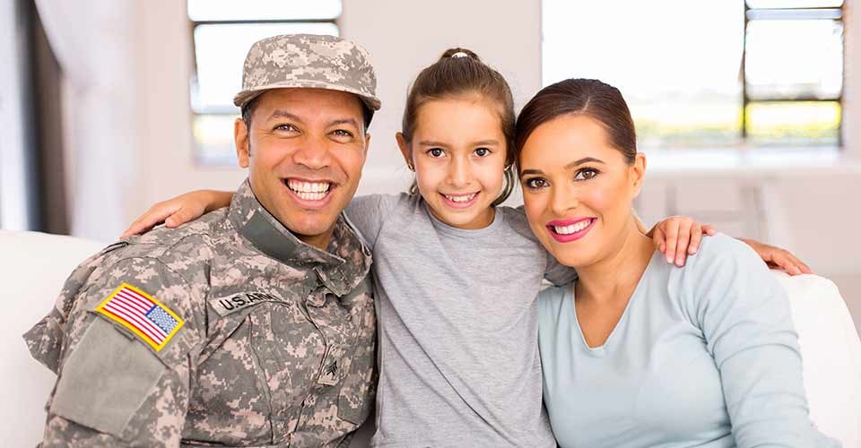 Military family sitting on the couch at new home