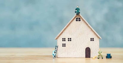 Miniature people climb and repair the house