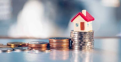 Miniature red house on stack coins