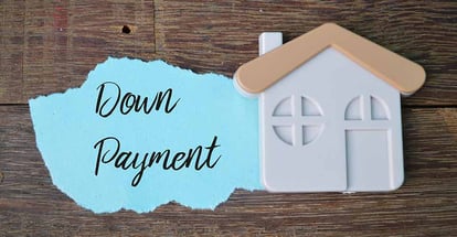 Model house and Down Payment written on torn paper