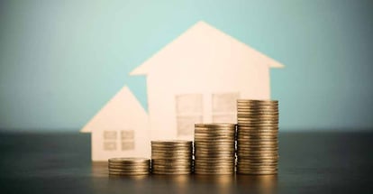 Model house and coins stack for buying investment property