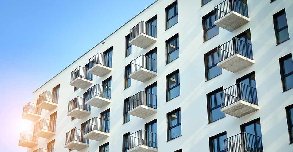 Modern apartment building on a sunny day with a blue sky