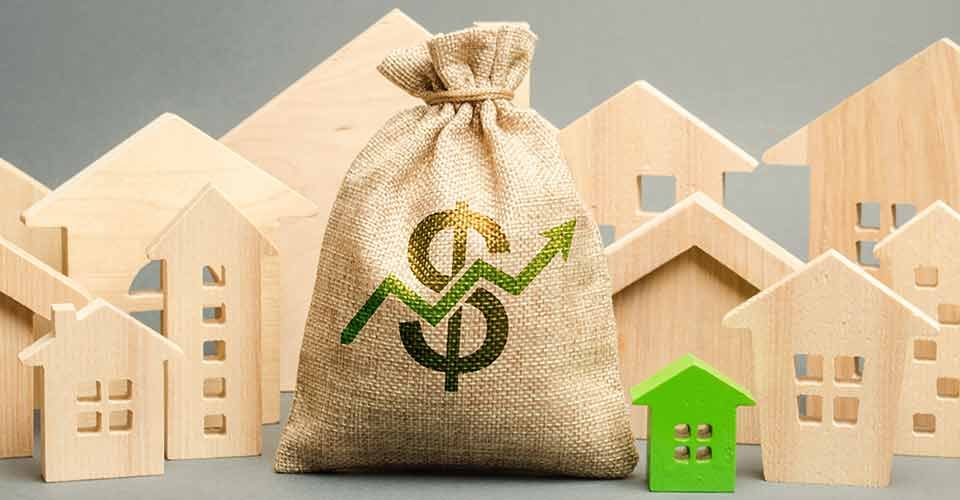 Money bag with arrow up and miniature wooden houses
