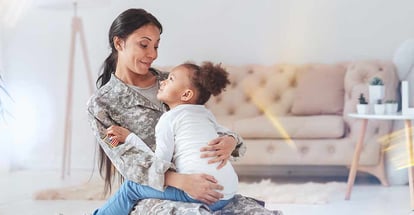 Mother in military uniform holding her daughter in new home