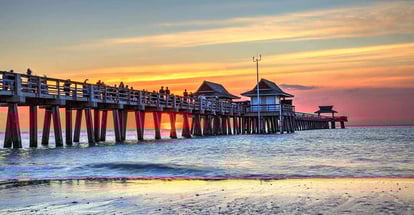 Naples Pier on the beach at sunset in Naples Florida