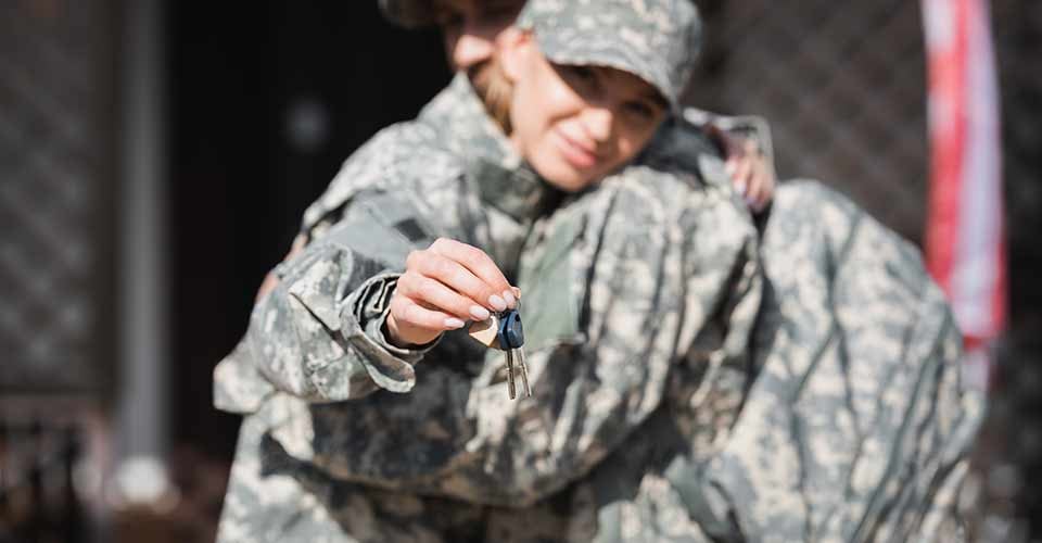 New house keys with military wife and husband hugging