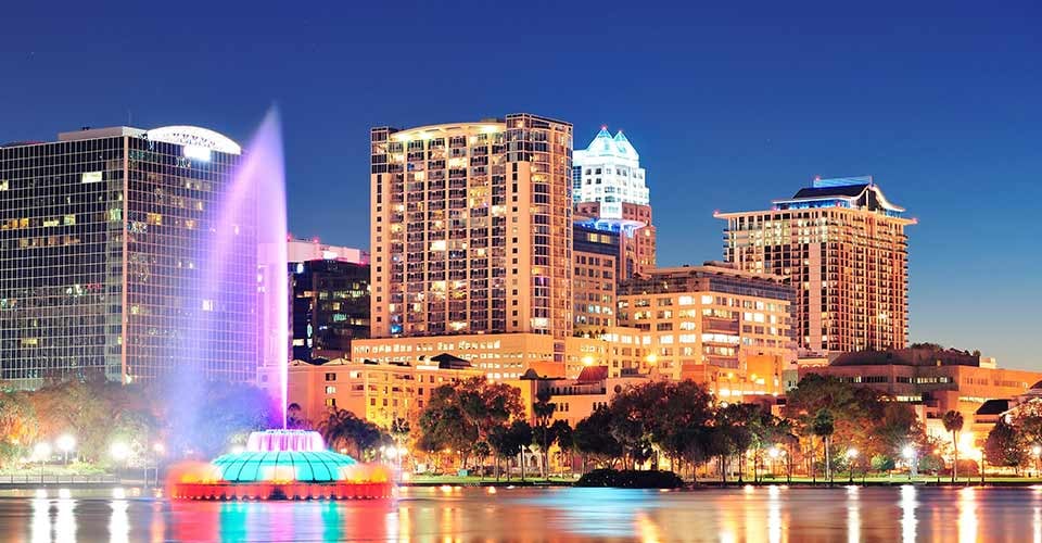 Orlando downtown skyline over Lake Eola at night with urban skyscrapers in Florida