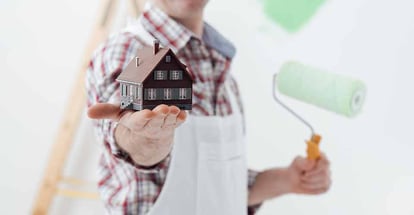 Painter holding model house and home renovation