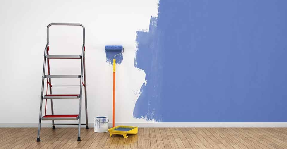 Painting walls of an empty room for house renovation