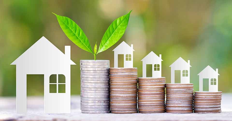 Paper house on coins stack for investment property