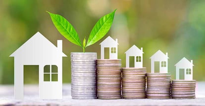 Paper house on coins stack for investment property