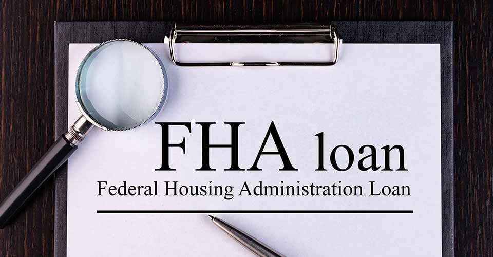 Paper with FHA loan on a table with pen and magnifier