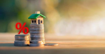 Percent Sign and Model House on stack of coins