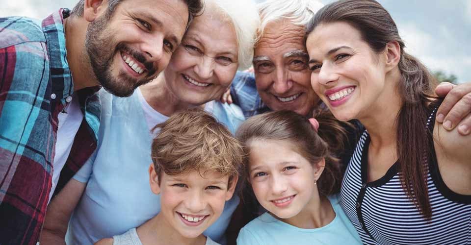 Portrait of happy multi generation family standing outdoors
