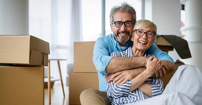 Portrait of happy senior couple in love moving in new home
