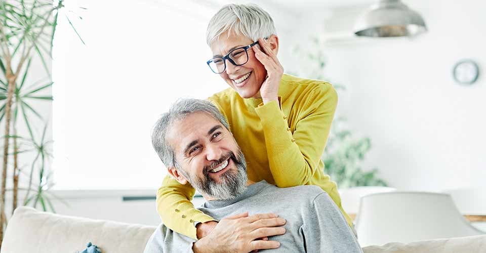 Portrait of happy smiling senior couple at home