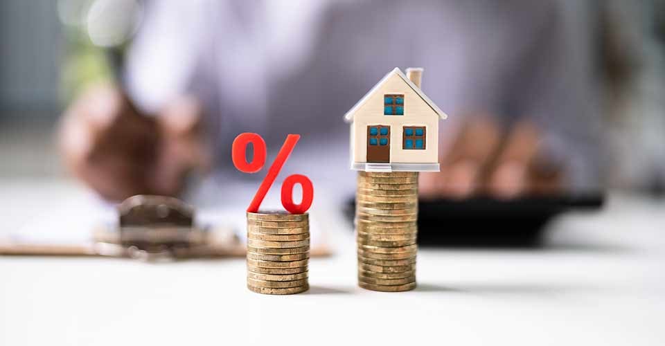 Real Estate Loan Percentage and Modal House on Coin Stack