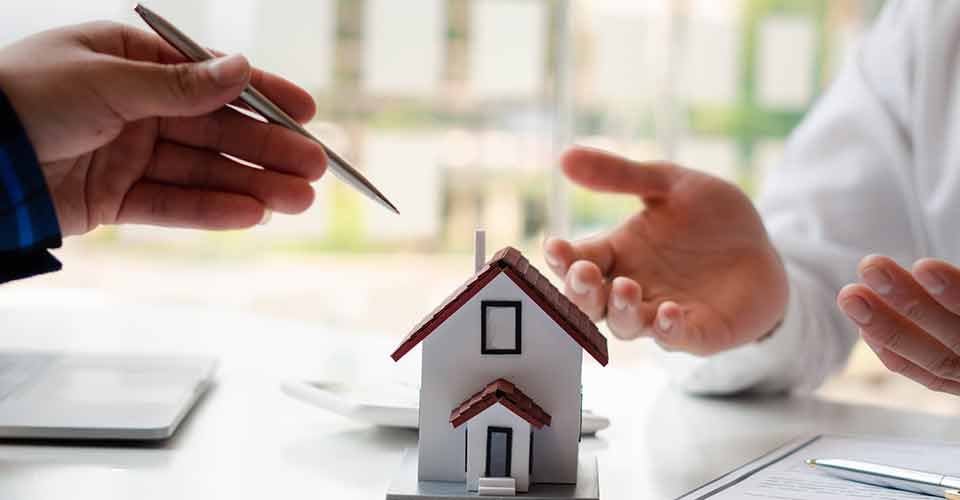 Real estate agent and buyer discussing about home purchase