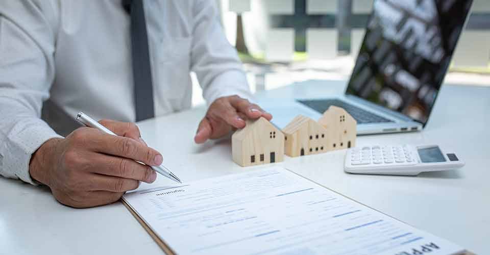 Real estate agent and customer signing contract for buying house