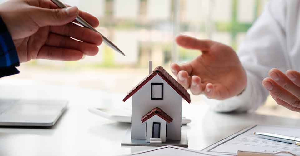 Real estate agent explains loan options for investment property to clients
