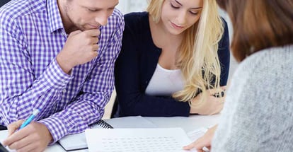 Real estate agent explaning about mortgages to a young couple