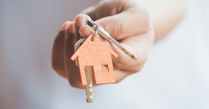 Real estate agent holding house key