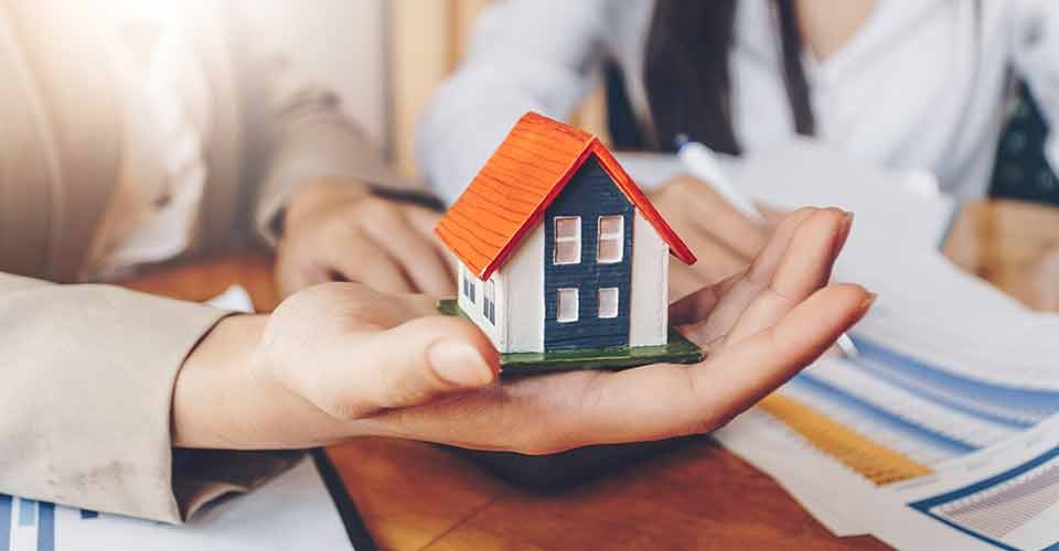 Real estate agent holds house model