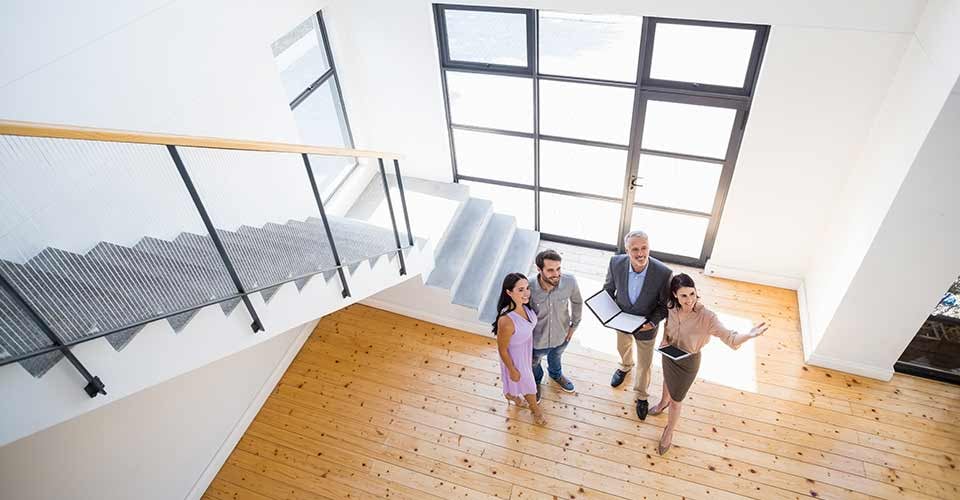 Real estate agent showing new house to couple