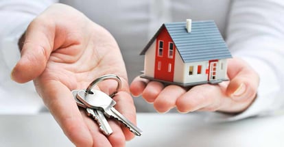 Real estate agent with house model and keys