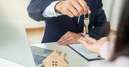 Real estate agents hold house keys for clients after buying house