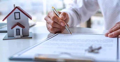 Real estate investor signing a contract to buy home